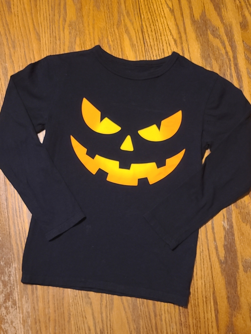 Place Black Long-Sleeve Tee with Bright Orange Jack-O'-Lantern Face